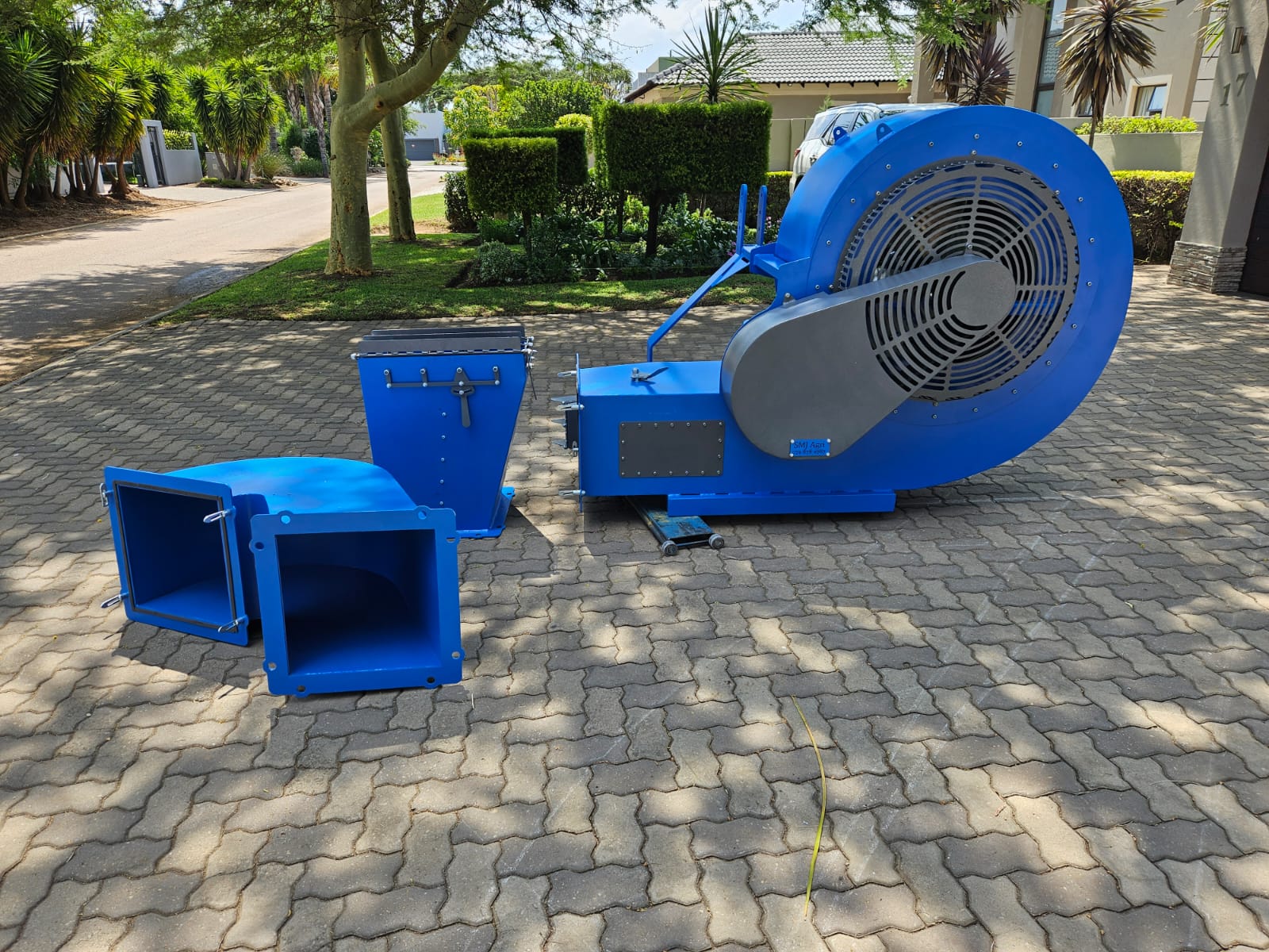 SMJ volume blower with its removable neck and 360 degree adjustable outlet parts laid out on paving